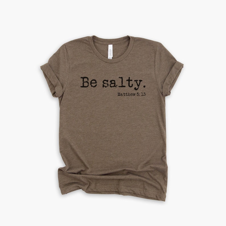 May include: A brown t-shirt with the text "Be salty. Matthew 5:13" printed on the front.