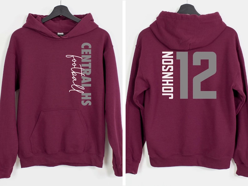 May include: Burgundy hoodie with a front pocket and hood. The front features the text "CENTRAL HS football" in white and gray. The back displays "JOHNSON" and the number "12" in gray.