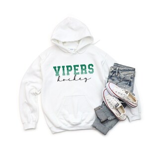 May include: White hoodie with a green and white striped graphic that says "VIPERS hockey" in a retro font.
