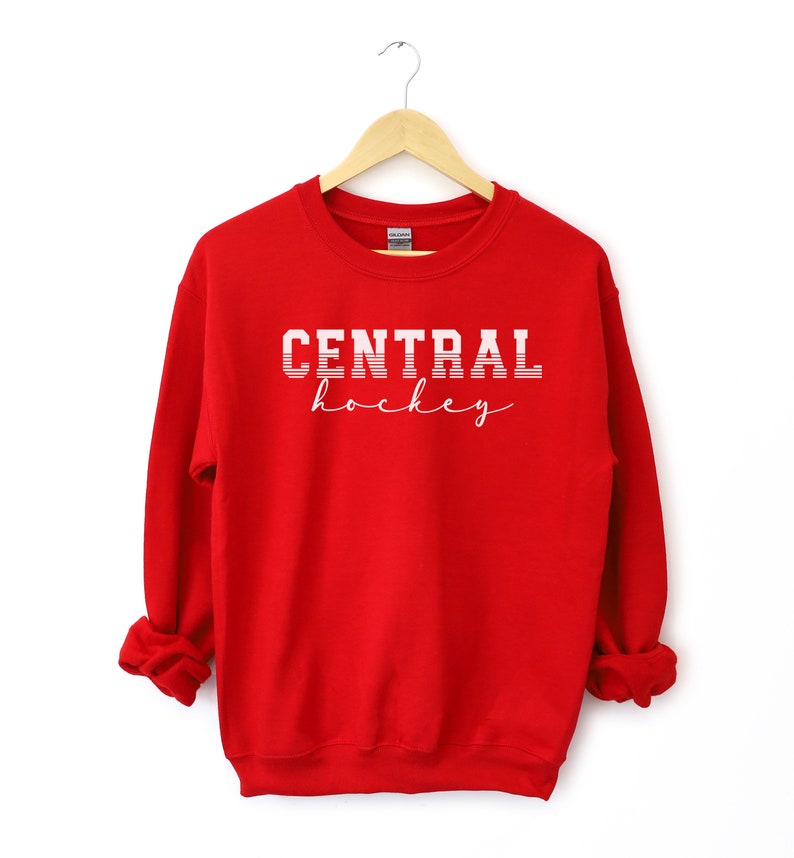May include: Red sweatshirt with white text that reads "CENTRAL hockey" in a vintage style font.