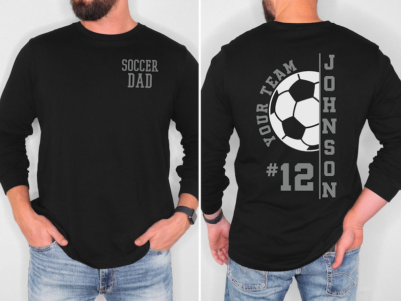 May include: Black long-sleeve shirt with a soccer ball graphic and the text "Your Team #12 JOHNSON" on the back. The front of the shirt says "Soccer Dad".
