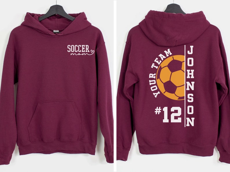 May include: Burgundy hoodie with a white soccer mom design on the front and a white soccer design with the text "YOUR TEAM #12 JOHNSON" on the back.