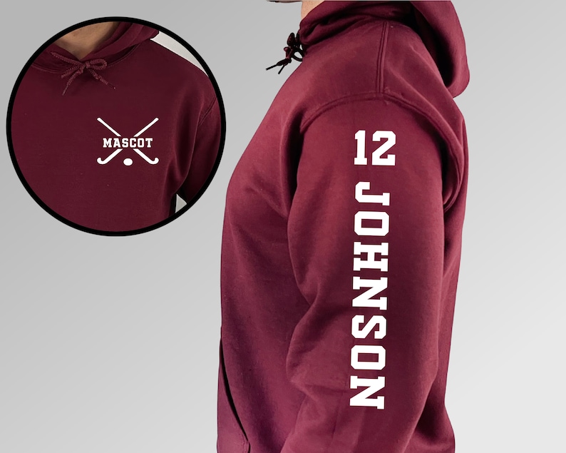 May include: Burgundy hooded sweatshirt with white text on the sleeve that reads "12 JOHNSON". The front of the sweatshirt has a white graphic of two crossed hockey sticks with a puck in the middle and the word "MASCOT" underneath.