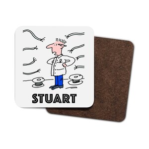 May include: A white coaster featuring a cartoon illustration of a man surrounded by electrical wires and spools of wire. The text "STUART" is printed below the illustration.