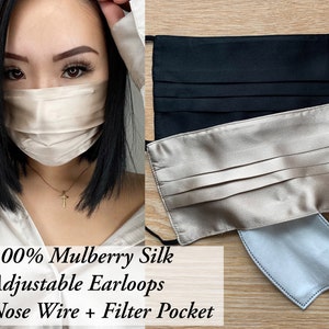 May include: Three silk face masks, one black, one beige, and one beige with a white filter. The masks have adjustable ear loops, a nose wire, and a filter pocket. 100% Mulberry Silk Adjustable Earloops Nose Wire + Filter Pocket