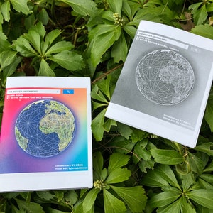 May include: Two copies of a book titled "The Becker-Hagenford: A 1980 Atlas" by Beth Becker and Bill Hagen. The book cover features a colorful globe with a rainbow background. The other copy is in black and white.