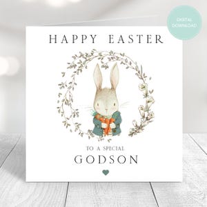 May include: A white card with a bunny rabbit holding a carrot in a wreath of green leaves. The card says "Happy Easter" and "To a special Godson" with a small heart.