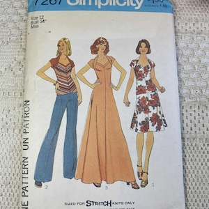 May include: Vintage Simplicity sewing pattern 7267 for Misses. Size 12, bust 34 inches. The pattern features illustrations of three different dress designs. The envelope is white and blue with the Simplicity logo at the top.