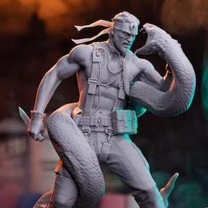 May include: A gray figurine of a muscular man with a snake wrapped around him, holding a knife. The man wears a headband, suspenders, and pants. The figurine is on a wooden base. The text "PATREON H3LL CREATOR" is at the bottom.