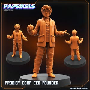 May include: Three orange-brown figurines of a person in a jacket and pants, holding a small fruit. The figures are on black circular bases. The text "PAPSIKELS" is at the top, and "PRODIGY CORP CEO FOUNDER" is at the bottom.