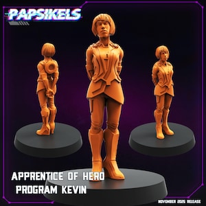 May include: Three orange figurines of a person in a futuristic outfit, standing on black circular bases. The text "Papsikels" is at the top, and "Apprentice of Hero Program Kevin" is at the bottom. The release date is November 2025.