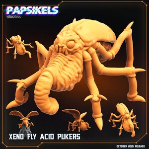 May include: A collection of light orange, insect-like figurines, including a large central figure with multiple legs and a segmented body. The text "Papsikels" is at the top, with "Xeno Fly Acid Pukers" and "October 2025 Release" at the bottom.