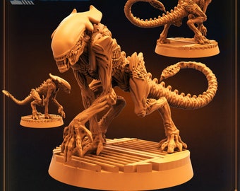 May include: A detailed, 3D printed miniature of a cheetah alien from the movie Alien. The alien is in a crouched position with its tail curled around its body. The miniature is painted in a brown and tan color scheme. The miniature is on a circular base with a textured surface. The miniature is labeled "Cheetah Alien - A".