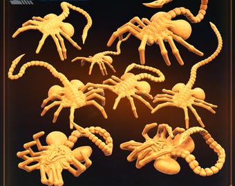 May include: A set of nine 3D printed alien creature figures, known as Xenomorphs, in a light brown color. The figures are posed in various positions, with their tails curled around their bodies. The figures are all facing the camera, and the text "XENO HUGGERS SET 1" is printed below the figures.