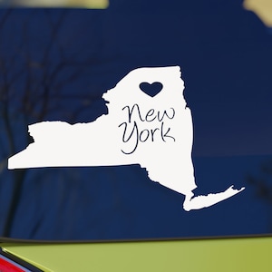 May include: White vinyl sticker of the outline of the state of New York with a heart in the center and the words "New York" written inside the outline.