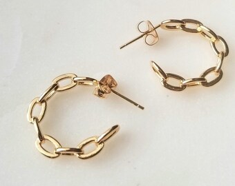 May include: A pair of gold hoop earrings made of linked oval chains.