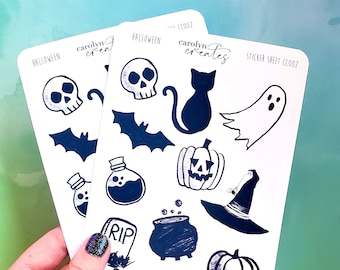 May include: Two sticker sheets with a Halloween theme. The stickers feature a variety of spooky designs, including a ghost, a witch's hat, a cauldron, a pumpkin, a bat, a skull, a potion bottle, and a tombstone. The sticker sheets are white with black ink and the text "Halloween" and "Carolyn Creates" is printed on the sheets.