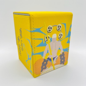 May include: Yellow deck box featuring a blue and white illustration of a person holding a spear with a circle of symbols above their head. The text "神楽" is written on the side of the box.