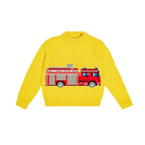 May include: A bright yellow knit sweater featuring a pixelated fire truck design in red, gray, and blue. The sweater has a crew neck and long sleeves, perfect for children's wear.
