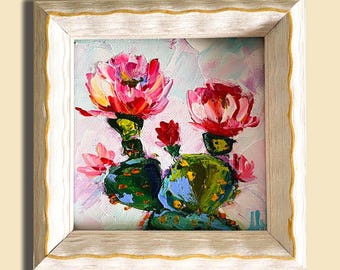 Peut inclure: Peinture à l'huile d'un cactus avec des fleurs roses vives et des coussinets verts, encadrée dans un cadre blanc et doré. L'œuvre d'art est de style impressionniste, idéale pour la décoration intérieure.