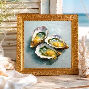 May include: A framed painting of three open oysters with yellow and green interiors, set against a light blue background. The painting is in a gold ornate frame, with a coastal theme. The scene includes a vase of white flowers and seashells.