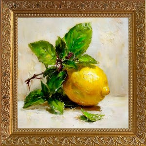 May include: Oil painting of a lemon with green leaves and small red buds. The lemon is yellow and sits on a white surface. The painting is in a gold ornate frame. The artwork is a still life.