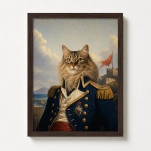 May include: Framed print featuring a cat in a military uniform, set against a landscape with a castle and a red flag. The cat has long, brown fur and is wearing a blue coat with gold accents and epaulettes.