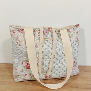 Quilted patchwork bag with floral fabrics in soft pink, grey, green and pastel tones
