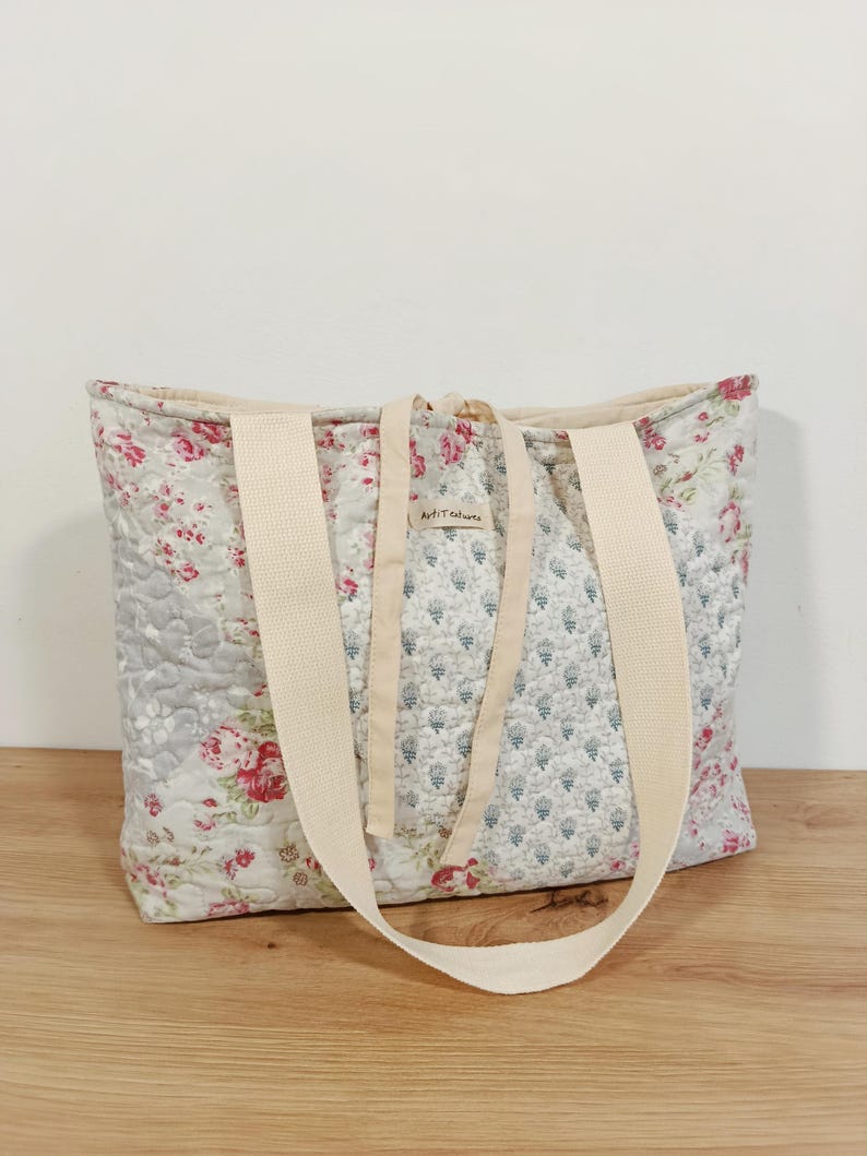 Quilted patchwork bag with floral fabrics in soft pink, grey, green and pastel tones