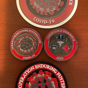 May include: Three round, red, white, and black badges with the text "Operation Enduring Fustercluck" and a stylized image of a coronavirus. The badges are a sticker, a metal coin, and a fabric patch. The metal coin also has the text "Coronavirus Task Force" and "2020".