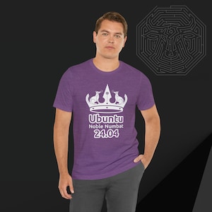 May include: A purple t-shirt with a white graphic of a crown with two animals on top. The text "Ubuntu Noble Numbat 24.04" is below the crown.