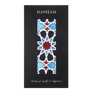 Large mulberry-silk scarf with Islamic geometry and Alhambra-inspired pattern, red border draped over a woman's shoulders.