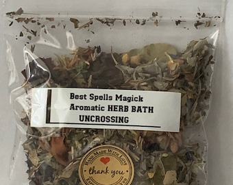 May include: A clear plastic bag filled with dried herbs and flowers. The bag has a label that reads "Best Spells Magick Aromatic HERB BATH UNCROSSING". A small brown label with a red heart and the text "HAND MADE WITH LOVE thank you ESPECIALLY FOR YOU" is also on the bag.