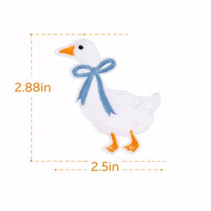 May include: Embroidered white goose patch with a blue bow, orange beak and feet. The patch measures 7.3 cm high and 6.35 cm wide. This decorative patch is ideal for adding to clothing, bags, or other fabric items.