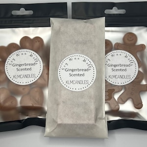 May include: Three bags of soy wax melts, each with a different gingerbread man design. The bags are labelled "Soy Wax Melts Gingerbread Scented KLMCANDLES".