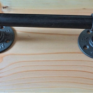 May include: Black industrial pipe handle with two flanges. The flanges are round and have a black finish. The handle is made of metal and has a smooth surface.