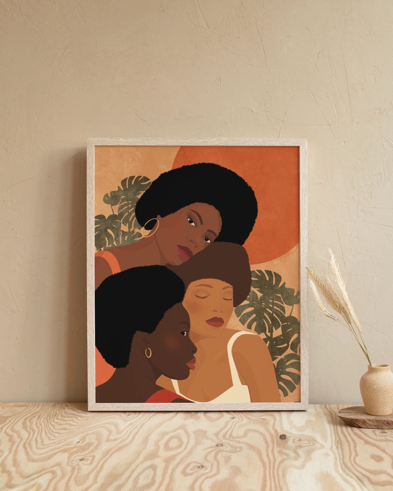 May include: A framed illustration of three Black women with afro hairstyles. The women are depicted in profile, with the woman in the back leaning her head on the shoulder of the woman in the middle. The background is a warm orange color with green leaves.