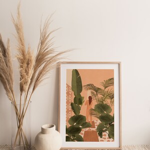 Puede incluir: Una ilustraci&oacute;n enmarcada de una mujer de pie en un exuberante jard&iacute;n tropical. La mujer est&aacute; de espaldas al espectador y sostiene una planta. El fondo es de color naranja melocot&oacute;n con follaje verde.