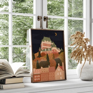 May include: A framed illustration of a cityscape at night with a large building on a hill, surrounded by trees and smaller buildings. The sky is dark blue with a crescent moon and stars. The buildings are a mix of red, brown, and white.