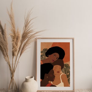 May include: A digital art print featuring three women with brown skin and afro hairstyles. The women are depicted in a close-up portrait with a warm, earthy color palette. The background features abstract shapes and tropical leaves.