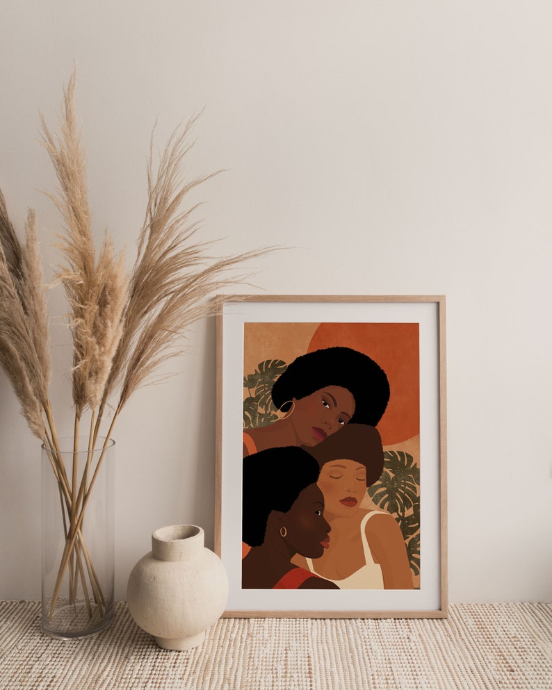 May include: A digital art print featuring three women with brown skin and afro hairstyles. The women are depicted in a close-up portrait with a warm, earthy color palette. The background features abstract shapes and tropical leaves.