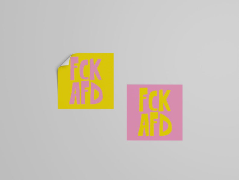 May include: Two square stickers with the text "FCK AFD" in pink letters on a yellow background and yellow letters on a pink background.