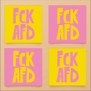 May include: Four square sticky notes with the text "FCK AFD" written in pink on a yellow background and yellow on a pink background.
