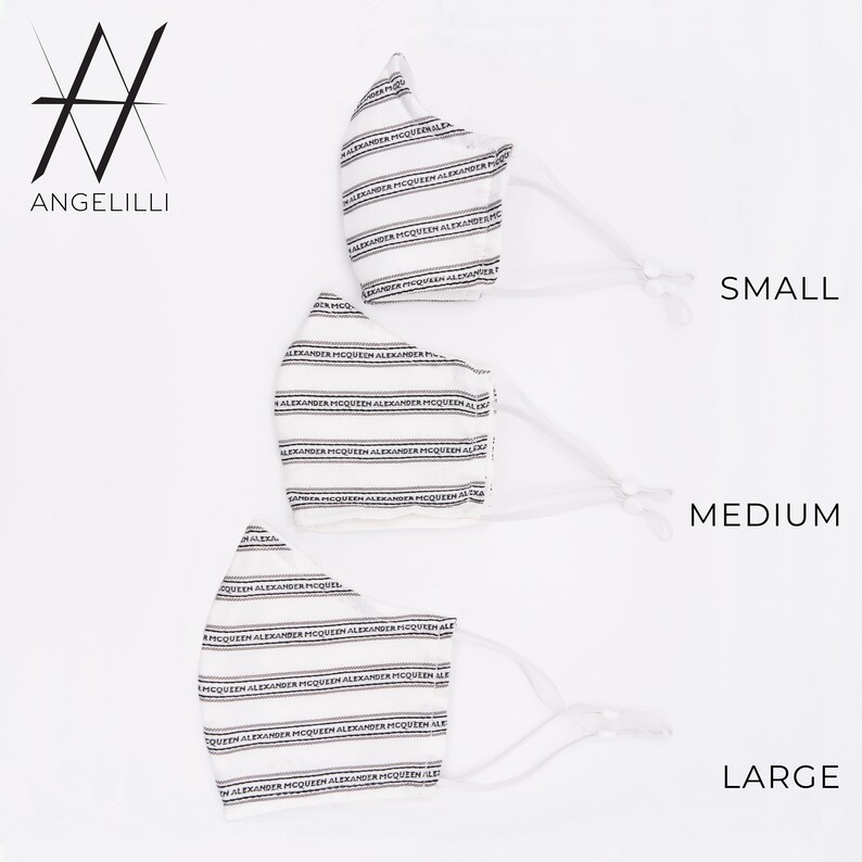 May include: Three white face masks with black stripes and the text "Alexander McQueen" repeated across the fabric. The masks are labelled "Small", "Medium", and "Large".