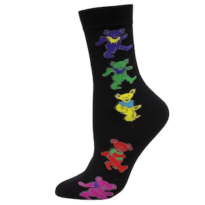 May include: Black socks featuring colorful dancing bears in purple, green, yellow, and red. The bears are in a row down the side of the sock. The socks are made of a soft material.