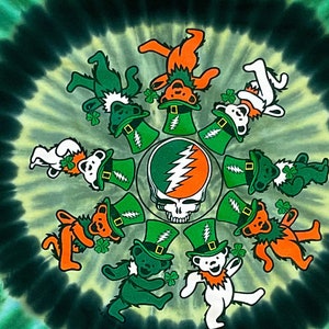 May include: A tie-dye green and orange t-shirt with a circular design of dancing bears wearing green hats and holding shamrocks. The center of the design features a skull with lightning bolts.