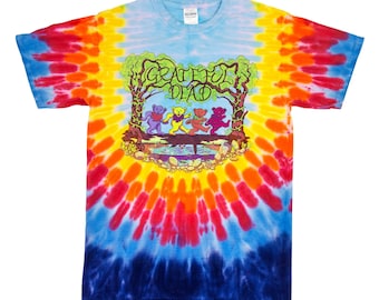 May include: Tie-dye t-shirt with a colorful Grateful Dead logo featuring four bears walking across a bridge. The logo is surrounded by trees and vines.
