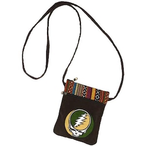 May include: A brown crossbody bag with a colorful woven top border and a zipper closure. The bag features a circular patch with a skull and lightning bolt design in yellow, green, and white. The strap is a thin, dark brown cord.
