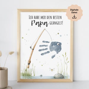 Könnte beinhalten: Eine druckbare Vatertagskarte mit einem Handabdruck-Fisch-Design. Die Karte lautet "Ich habe mir den besten Papa geangelt!" was übersetzt "Ich habe den besten Papa geangelt!" bedeutet.