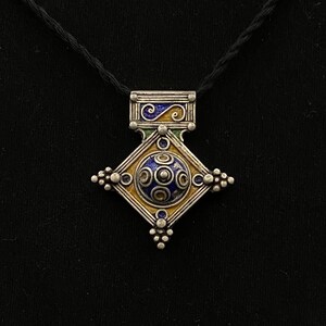 Silver ethnic pendent with enamel work .